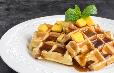 Belgian chocolate waffles with chocolate syrup.