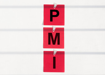 PMI acronym word from red notes with letters, abbreviation PMI Private Mortgage Insurance, Purchasing Managers Index concept
