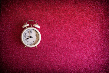 Vintage alarm clock with old white bells, with bright red background. Concept of a retro watch. Copy space
