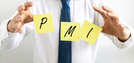 PMI acronym word on yellow paper in hand of businessman with letters, abbreviation PMI Private...
