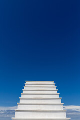 White stairs on beautiful sky background. White wooden walkway. Walk route concept to highest point.