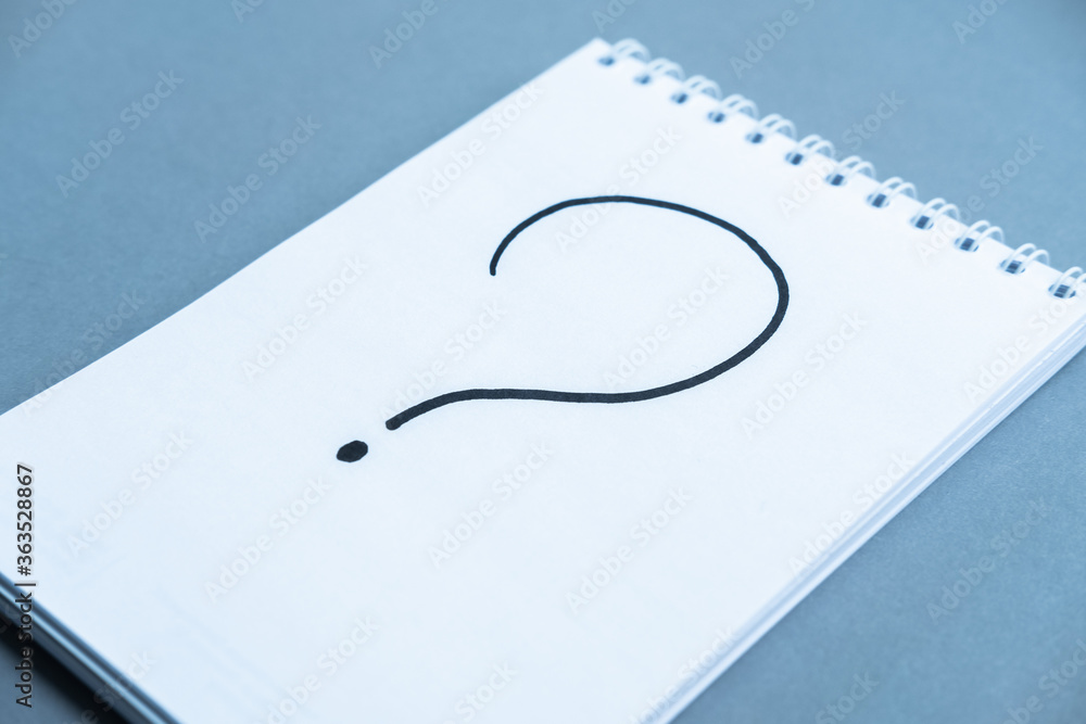 Fototapete notebook with the schedule shoot from the top. spiral notebook blue background. question mark writte