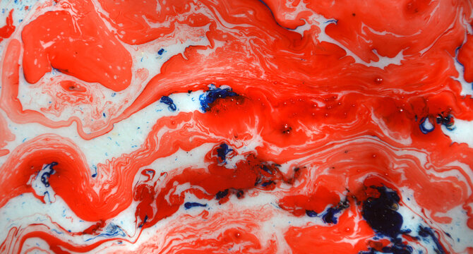 splash of paint.Closeup abstract color mixing of water, acrylic,oil and milk for use as background image. Acrylic texture with marble pattern, red color background 