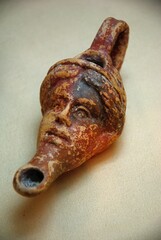 Human head shaped ancient ceramic oil lamp