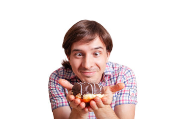 Funny man looks at the chocolate doughnut bulging eyes, a very funny photo on a white background. Empty space for text. A man loves sweets chocolate. World Chocolate Day stock images