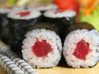 Japanese maki roll with tuna on a wooden tray close-up
