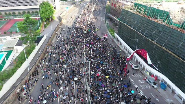 Aerial Shot Of Crowds Of Protesters Tearing Down Chinese Banner During Extradition Protests In Down Town Hong Kong