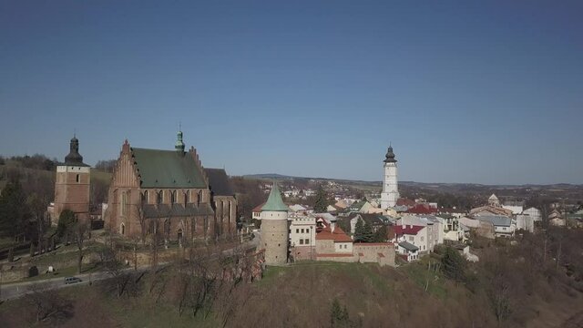 Biecz, Poland - 3 9 2019: Panorama of the historic center of the European medieval city on the picturesque green hills. Trips to architectural monuments: temples, central square, town hall, municipal