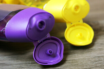 Yellow and purple tube bottle of shampoo, conditioner, hair rinse, gel, soap