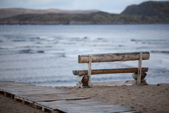 wooden bench on the beach © maodoltee