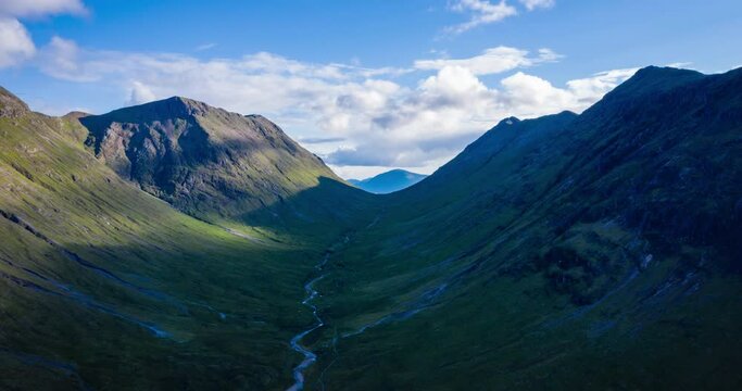 aerial footage of rannoch moor and buachaille etive mor with surrounding mountains near glencoe in the argyll and lochaber region of the highlands of scotland during a summer evening