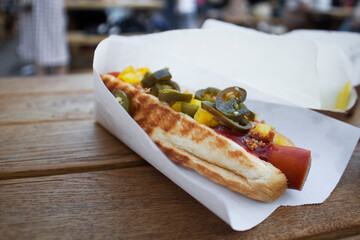 Hot dog with grilled sausages, onions and vegetables. Street food