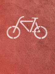 Fotobehang Rood Stockfoto van een bord met fietspad dat op de grond is geschilderd