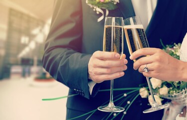 Young beautiful couple in the wedding day with glasses of champagne