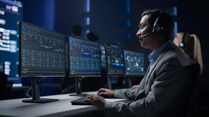 Professional Customer Support Specialist Wearing Headset Talks with Client and Works on Computer in Big Call Center Control Room. Team of Sales Representatives Service Providers Talk with Investors - Powered by Adobe