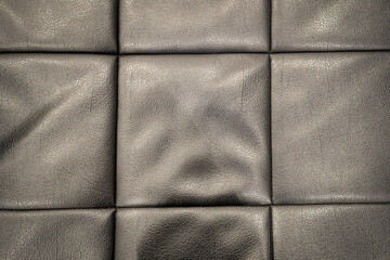 Black leather sofa texture background surface.