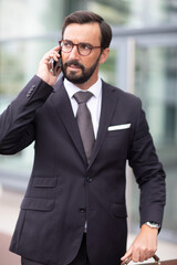 a businessman on the phone walking outdoors