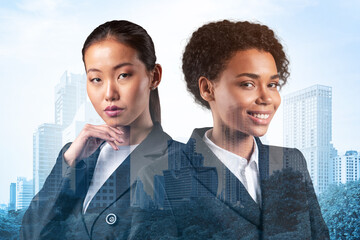 Two young attractive businesswoman in suits dreaming about new career opportunities after MBA graduation. Concept of multinational corporate team Bangkok on background. Double exposure.