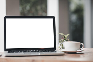 Mockup of laptop computer with empty screen with coffee cup on table of the coffee shop background