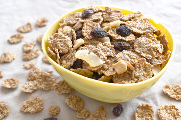Fruit and fiber cereal on a bowl. The concept of healthy breakfast, healthy food, dietary plan and weight loss program. Selective focus. Copy space is on the left side.