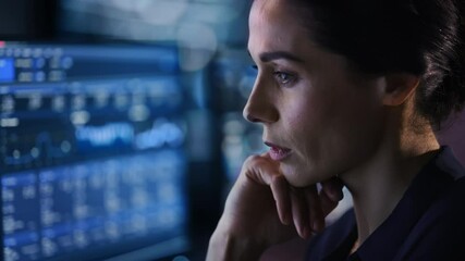 Confident Beautiful Middle Aged Woman Looks at Monitor Screens Focused