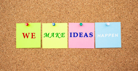 Multicolor notes with letters pinned on a cork notice board.