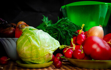 vegetables in a blue cup ripe red tomato sweet pepper dill onion radish beets orange carrots cucumber white cabbage with a filter for water