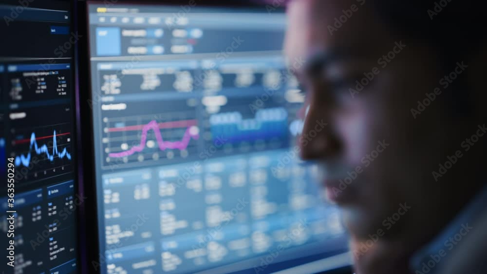 Poster Confident Handsome Man Looks at Monitor Screen with Camera Moving to Computer Screen Showing Data, Infographics, Information, Statistics, Numbers. Businessman Working on Computer in the Office