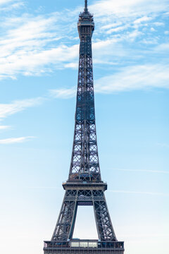 Famous Paris monument - Eiffel Tower. Must see for all the tourist. Blue sky with white clouds on background. Sunny summer day