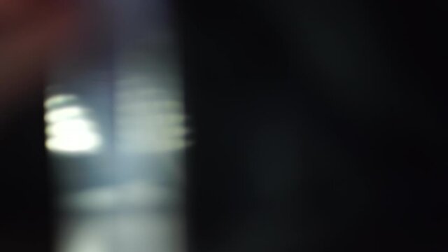 glass prism rotating in front of camera lens, real in camera light leaks or flares in 4k.