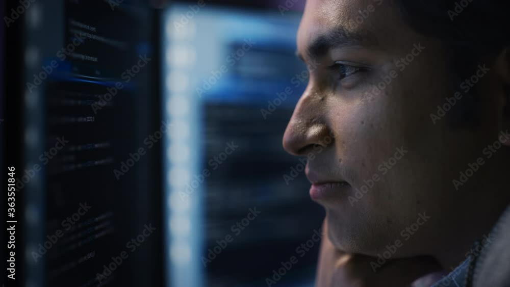 Poster confident handsome man looks at monitor screen with camera moving to computer screen showing data, i