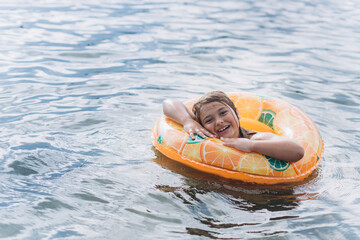 Young girl portrait on sea. Swimming children activity 