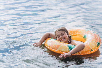 Young girl portrait on sea. Swimming children activity 