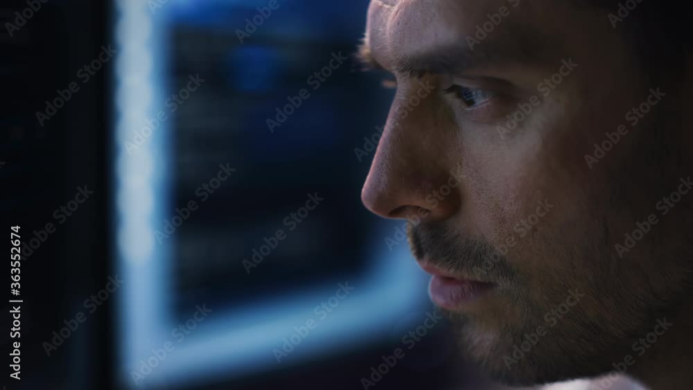 Leinwandbilder confident handsome man looks at monitor screen with camera moving to computer screen showing data, i