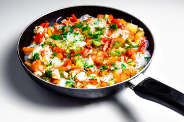fungoza salad cellophane rice and delicious tasty vegetables red bell pepper carrots cucumber dill greens tomato onion shredded fried chicken meat in a pan with a handle together on a white background