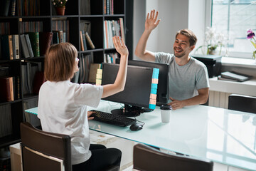 Team of programmers game designers have finished working on a new project. Photography for ad IT technology