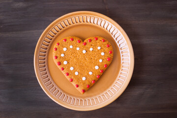 Christmas cookies lie on a saucer on a wooden background