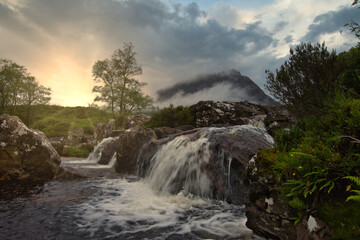 Fototapeta na wymiar waterfalls of Glencoe with sun glow, Glencoe, highlands, Scotland.