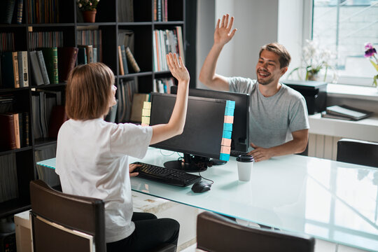 Team of programmers game designers have finished working on a new project. Photography for ad IT technology