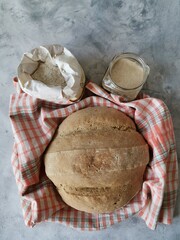 vertical composition with rye bread, flour and sourdough
