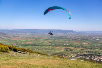 Paraglider in the popular area for parachuting on the side of Korylovos in Drama