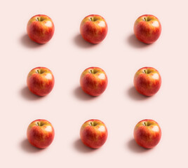 Fresh raw red apples pattern at pink background