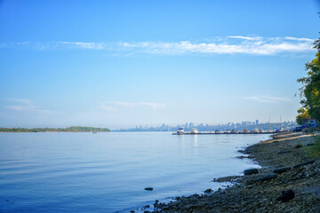 View of the big river, beyond which you can see the pier with boats and city.