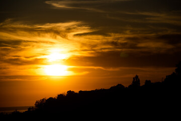 Contrast background with a bright setting sun and cloud