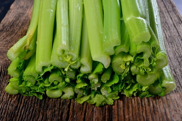 Sliced fresh celery stalk on old wooden board