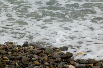 waves on the beach with pebbles