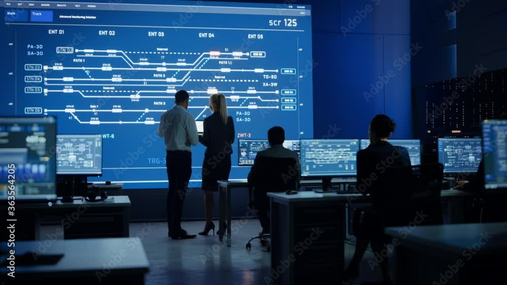 Aufkleber Telecommunications Company System Control and Monitoring Room with Diverse Multicultural Team of Professionals Working on Computers. Big Screen Display Showing Infrastructure Infographics. Back View