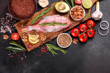 Raw fillet of red sea perch prepared for baking with spices and herbs