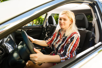 Fototapeta na wymiar Young woman driving her car