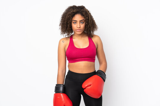 Young African American sport woman isolated on white background with boxing gloves